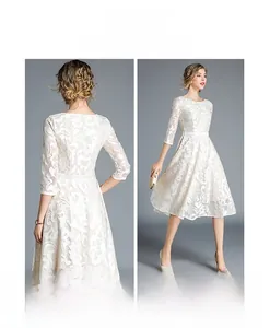 Detailed view of white floral lace embroidery on elegant mid-length slim fit dress