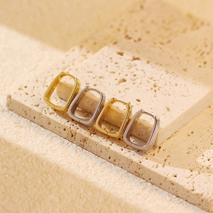 Detailed view of rectangular geometric s925 silver hoop earrings in gold and silver