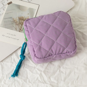 Purple and white checkered quilted cosmetic bag with green zipper and blue pull cord