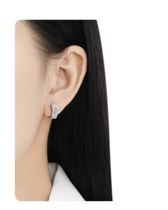 Side view of woman wearing silver S925 sterling silver clover earrings with cubic zirconia