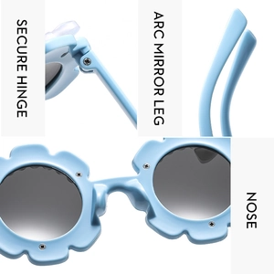 Detail of light blue flower kids sunglasses featuring secure hinge and arc mirror legs