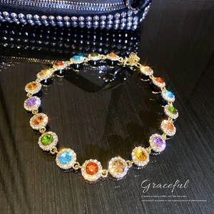 Luxurious gold-plated necklace with round colorful gemstones and shimmering diamond pavé