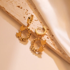 Gold-plated titanium steel hoop earrings with textured butterfly charms and small crystals