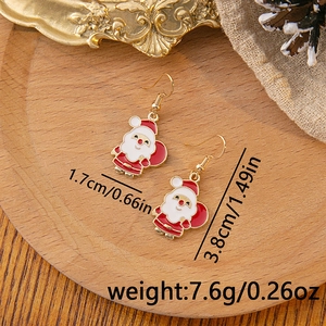 Detailed view of Santa Claus earrings with dimensions 3.8cm height on a wooden coaster