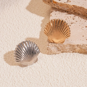 Polished shell-shaped ear cuffs in gold and silver finish with detailed ribbed texture