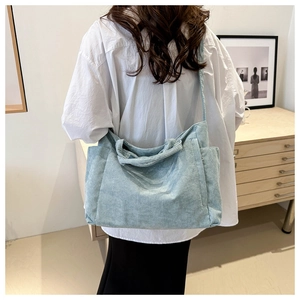 Light blue corduroy tote bag shown on model's shoulder for casual daily wear