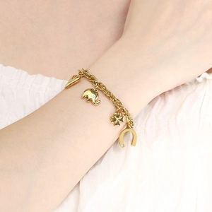 Detail of 18K gold-plated stainless steel bracelet with heart and clover charms
