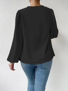 Rear view of black chiffon long sleeve blouse showing fabric texture and back cut