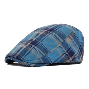 Detail of blue plaid cotton flat cap showing retro woven texture and side profile