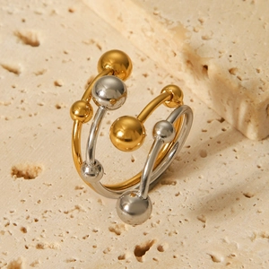 Detail of two-tone gold and silver stainless steel layered ring with polished beads