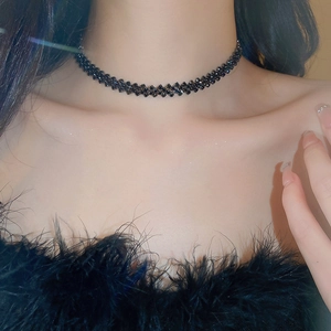 Close-up of a multi-row black crystal choker necklace with a sparkling woven mesh design
