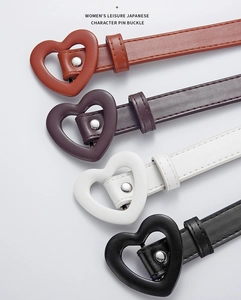 Close-up of colorful children's PU leather belts with heart-shaped metal buckles