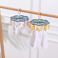 Detail of multi-color plastic clothes pegs on a rack for laundry drying and organization