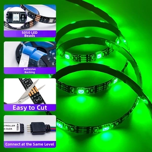 Detail view of 5050 RGB LED strip showing self-adhesive backing and cuttable marks with green light