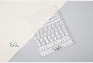 Close-up of white 5D lace nail stickers with floral and geometric patterns, style TS-073