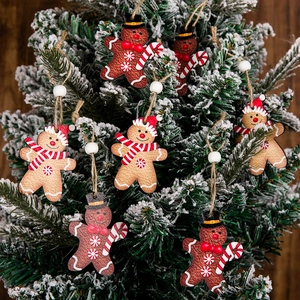 Gingerbread man wooden Christmas tree pendants with snow-covered branches decor