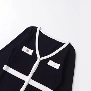 Women's V-neck knit cardigan in black and white contrast with elegant gold buttons