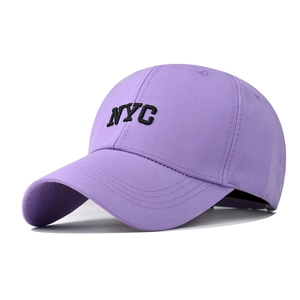 Detail of purple cotton baseball cap featuring black NYC embroidery and curved brim