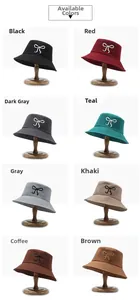Detail view of bow-embroidered bucket hats in eight colors on display stands