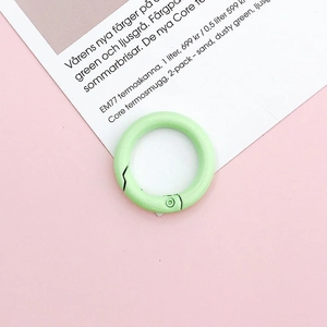 Macro detail of a 25mm light green matte metal O-ring with spring clasp closure