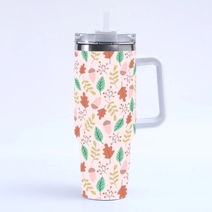 Detail of 40oz stainless steel tumbler featuring autumn leaf patterns and clear straw lid