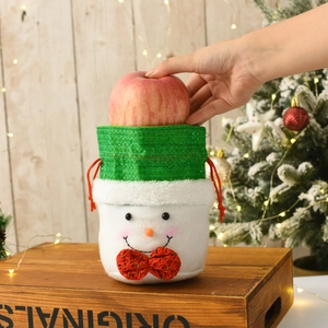 Detail of Christmas snowman drawstring gift bag with green plaid and red bow decoration