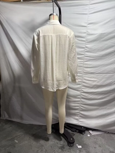 Detailed back view of a white loose-fit shirt with unique textured crinkle fabric