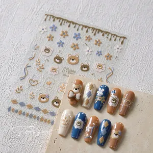 Detail of 3D embossed teddy bear nail stickers with matte finish and floral motifs
