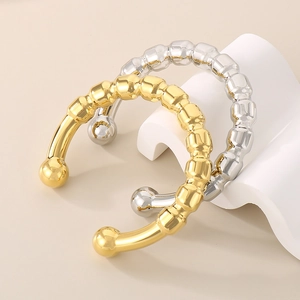 Exaggerated hollow titanium steel bangles with gold and silver bead endings in 18k plating