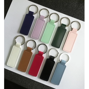 Ten colorful PU leather rectangular keychains with metal rings on white background