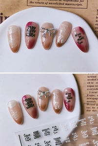 Detail of 3D nail art stickers with cursive English text and silver bow on gradient nails