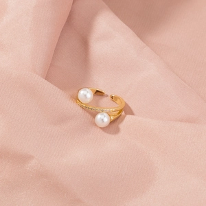 Macro view of gold plated open ring featuring elegant pearls and zircon micro-paving detail