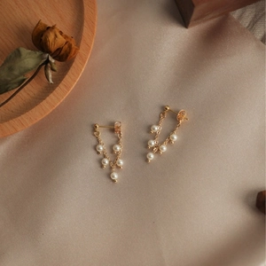 Elegant gold earrings with natural freshwater pearls in a vintage tassel drop design