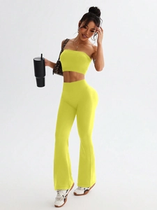 Detail of neon yellow seamless yoga set featuring a tight tank top and high-waist flare pants