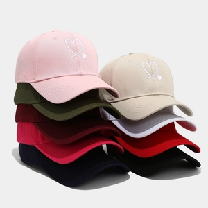 Multiple colors of baseball caps with heart embroidery in a clean stacked product display
