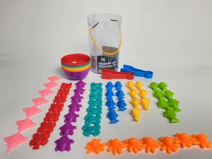 Flat lay of rainbow animal sorting toys set with colorful bowls and tongs for kids