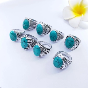 Detailed set of eight vintage silver alloy rings featuring turquoise oval stones