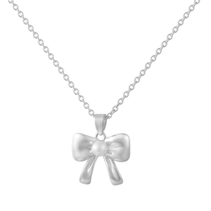 Detail of silver bow pendant with centered white pearl on a delicate metal chain