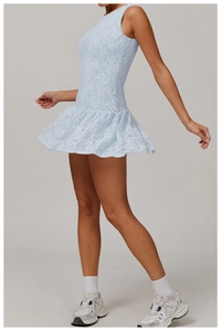 Close-up of light blue lace dress showing intricate floral embroidery and ruffled hemline