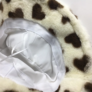 Detail of plush bucket hat interior showing white satin lining and adjustable drawstring