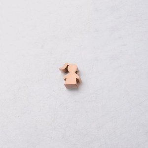 Macro shot of rose gold girl-shaped stainless steel pendant with polished mirror finish