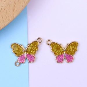 Macro shot of colorful butterfly pendants with gold metal frames and sparkling sequins