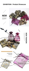 Detail of Halloween drawstring organza gift bags with gold spider web and pumpkin patterns