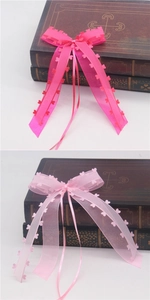 Detail of pink heart-patterned ribbons for wedding car mirrors and gift wrapping decor