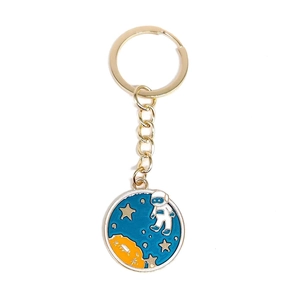 Astronaut space themed keychain with blue enamel star and planet charms on gold alloy