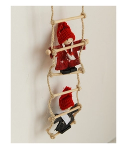Detail of felt Santa Claus figures climbing a wooden rope ladder for Christmas tree decor