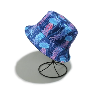 Detail of sun bucket hat featuring colorful jellyfish print on blue polyester fabric