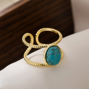 Bohemian gold-plated adjustable ring featuring a turquoise stone on a minimalist surface
