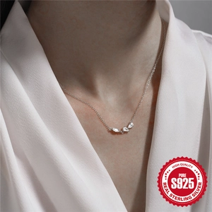 Minimalist 925 sterling silver necklace with marquise-cut zircon cluster pendant on a model