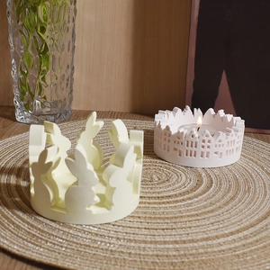 Easter rabbit plaster ring and white house candle holder on a woven mat for home decor